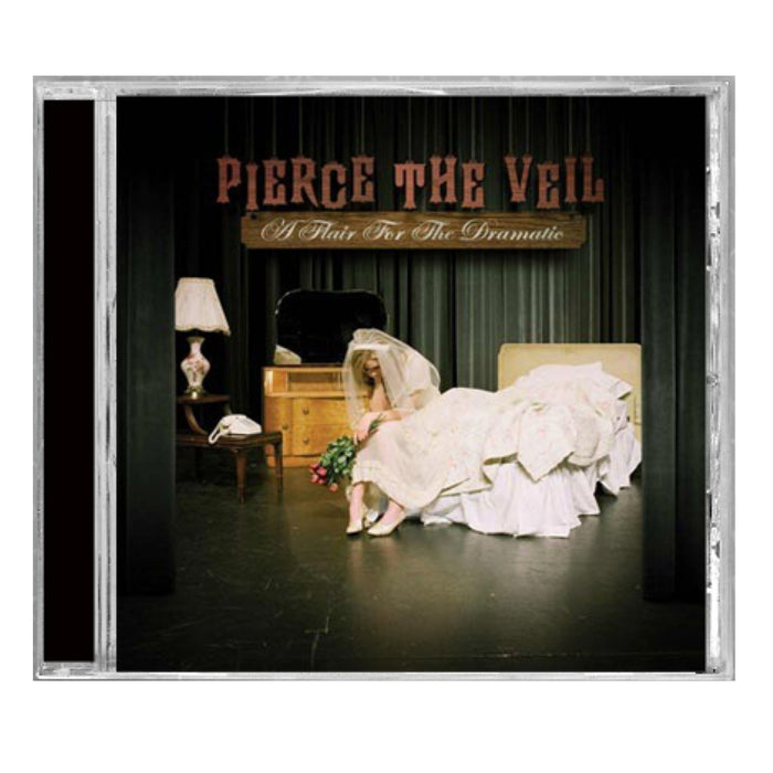CD cover for Pierce The Veilβs A Flair For The Dramatic features a woman in a wedding dress on a bed with flowers, lamp, phone, and mirror under stage lightsβa standout album from the band Pierce The Veil.