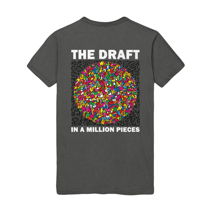Photo of the front of the shirt, The shirt has a circular design. The Pattern is of colorful shards of stained glass. The text "THE DRAFT" is on the top. The text on the bottom reads "IN A MILLION PIECES".