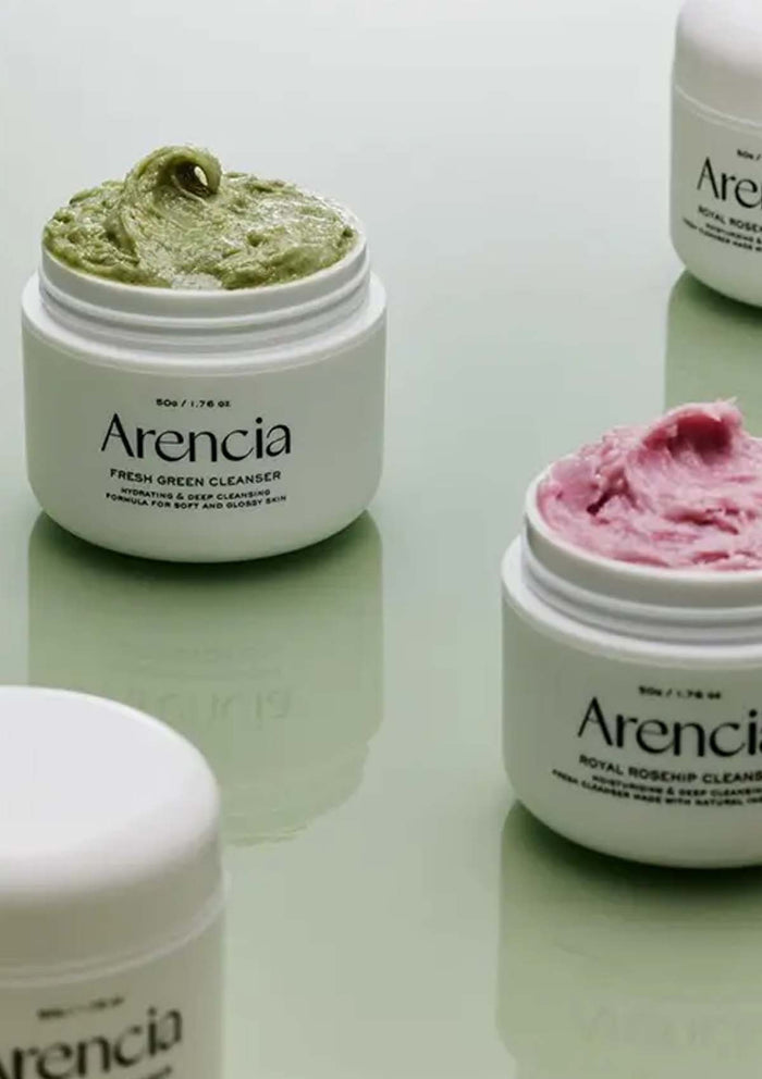 Three jars of Arencia skincare products on a light green background