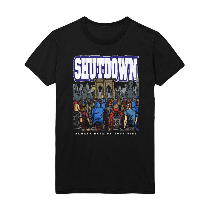 This black T-shirt has an image of a mob of people at the entrance of a castle moat with the words "Shutdown: Always Here By Your Side" on it.