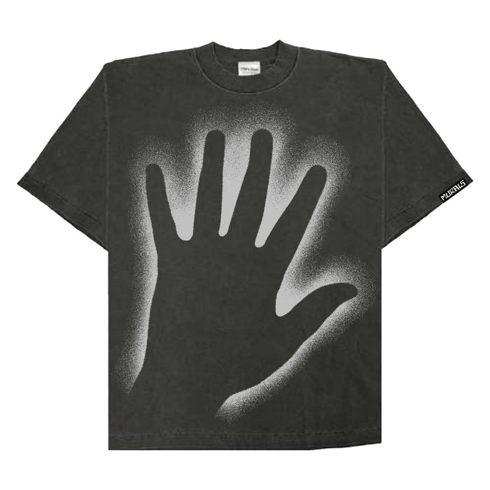 The Murals black oversized T-shirt showcases a bold, light gray spray-paint handprint at the center and features a small rectangular printed tag with text on the sleeve.