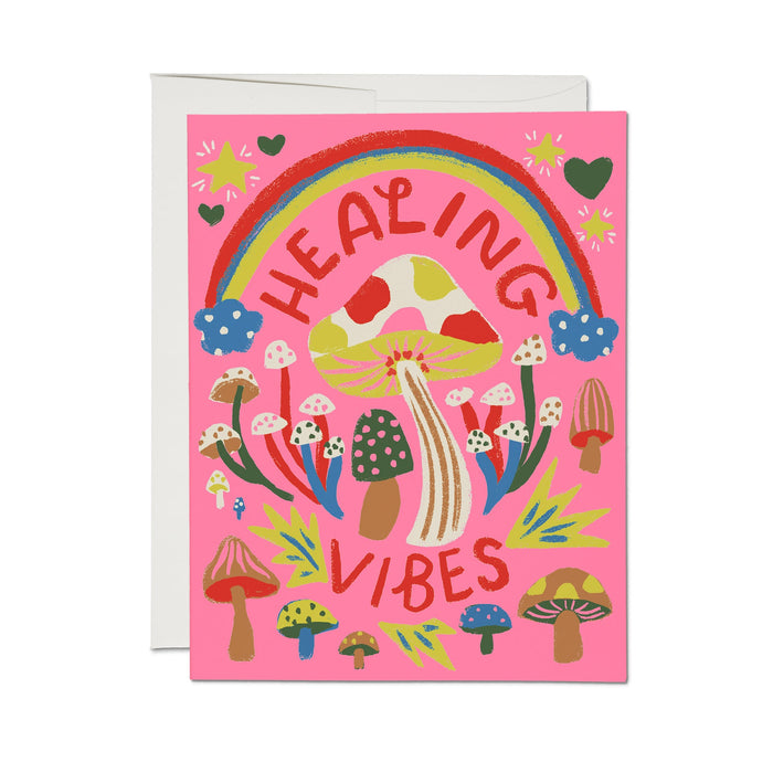 Greeting card with pink front, rainbow, mushrooms, hearts, and βHealing Vibesβ text