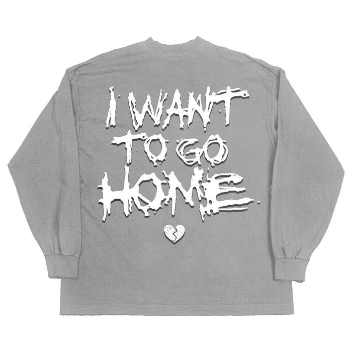 On the back of the gray top, the words "I want to go home" are in big white letters, along with a broken heart icon.