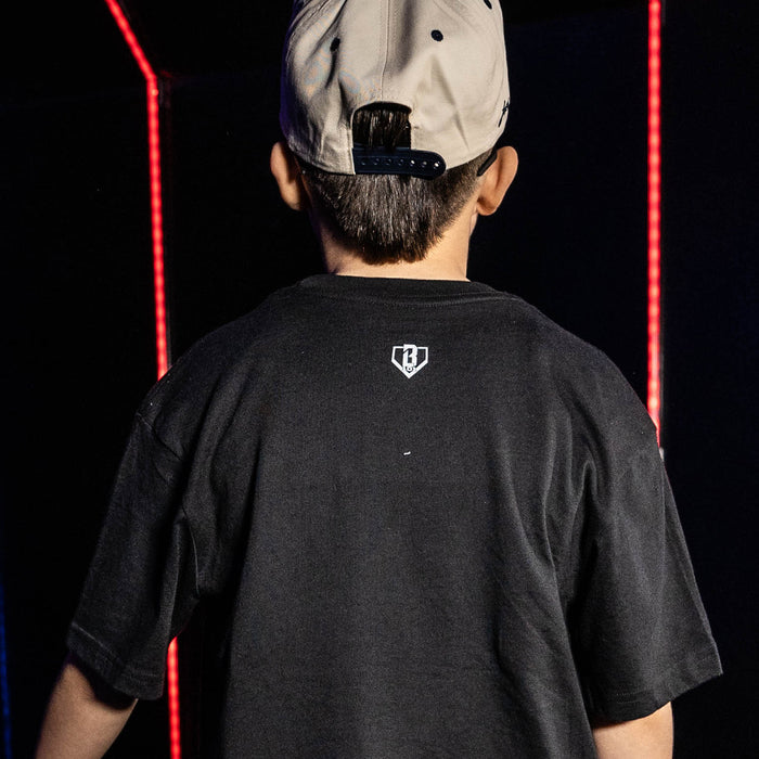 Youth model wearing black youth graphic tee with "New York Yankees Upside Down" design