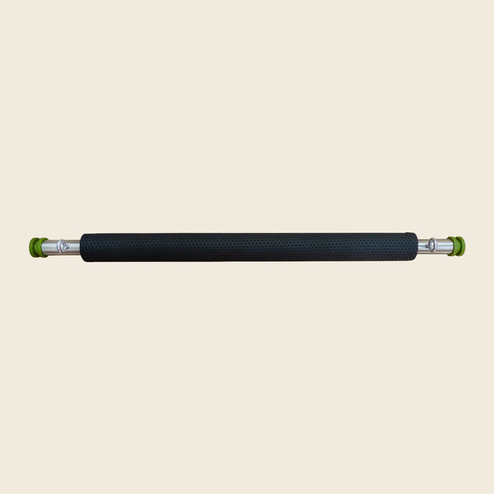 Black textured padded cover fitted over a Pilates guillotine tower rod with green end caps.