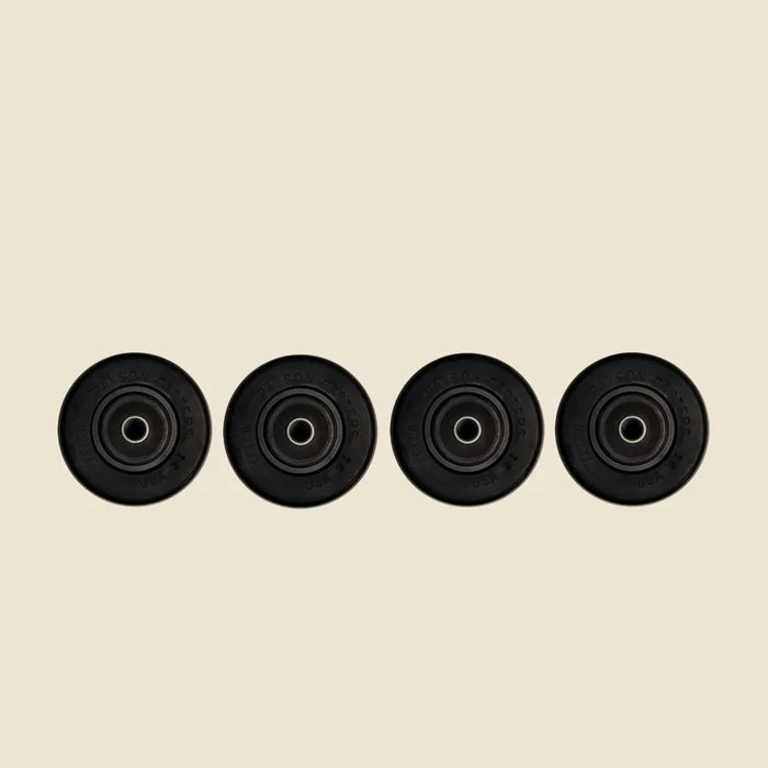 Set of 4 Carriage Reformer Wheels in front of Beige Background.