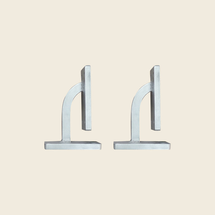 Pair of galvanized metal replacement shoulder blocks for a Pilates Reformer, shown side by side.