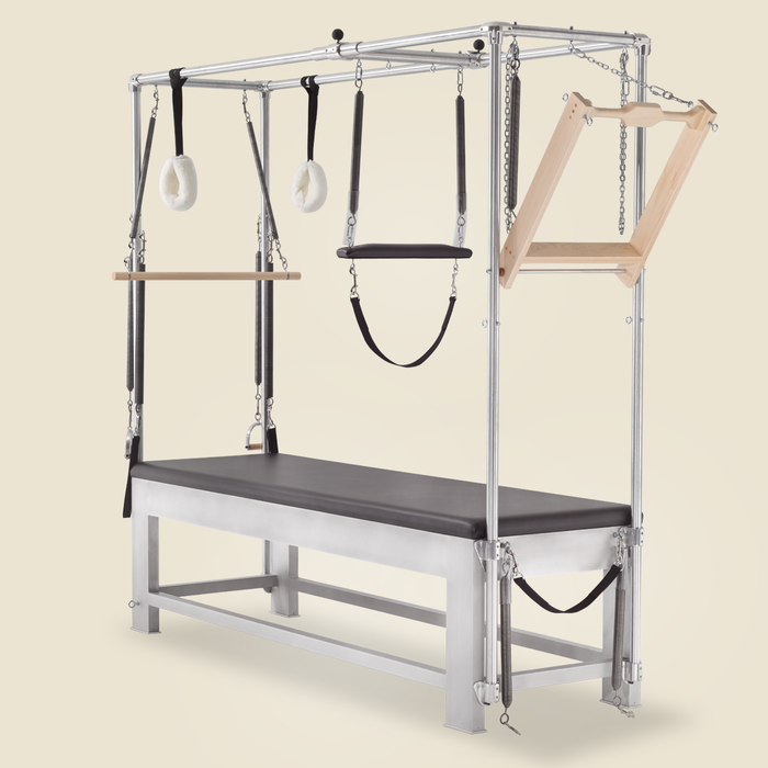 Roll down bar with springs mounted atop a classic aluminum Cadillac Pilates apparatus.