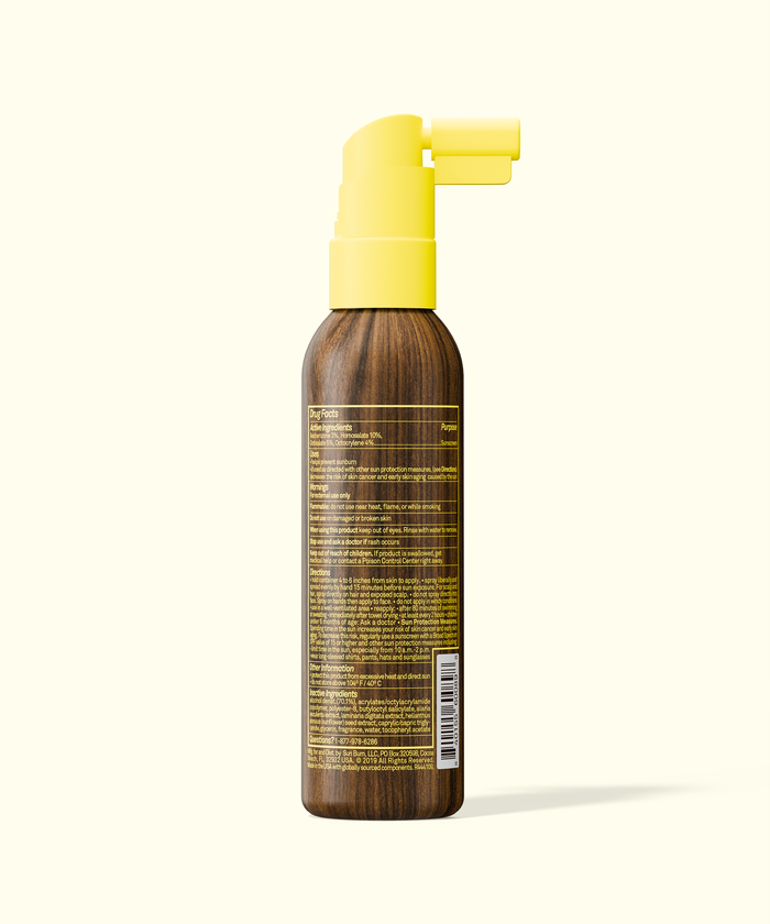 Brown spray bottle with yellow nozzle on a white background