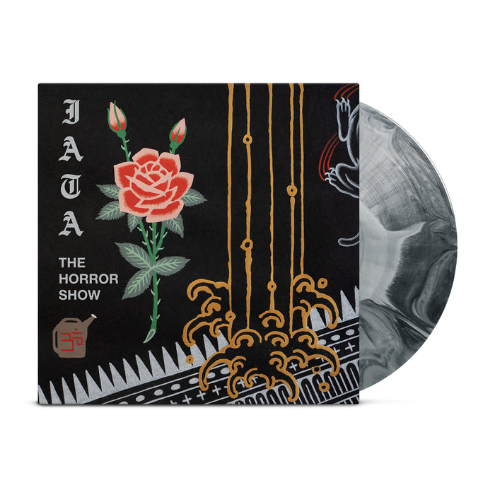 A vinyl record partially inside a sleeve. The sleeve displays a red rose, ornate gold lines, and patterns on black. Text reads "JATA THE HORROR SHOW." This limited I Am The Avalanche vinyl features a striking black/grey starburst design.
