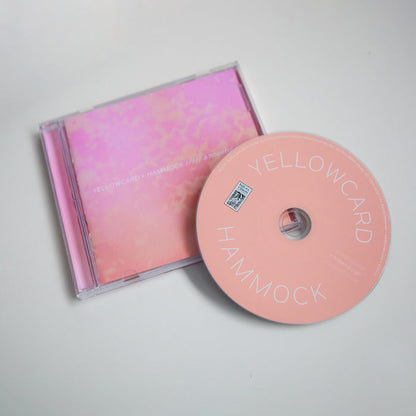 A pictue of the CD outside of the case. The CD is a light pink and "YELLOWCARD" HAMMOCK" is printed in white lettering on the top and bottom, respectively.