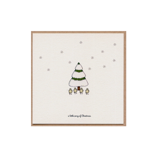 Christmas card with a small illustrated green tree and star dots on cream paper