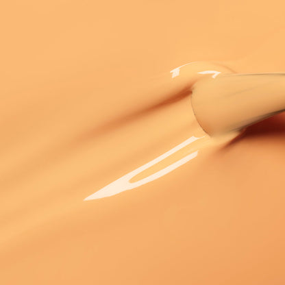 A close-up of a Manucurist Abricot nail polish brush applying glossy apricot orange gel polish in smooth strokes on a matching background.