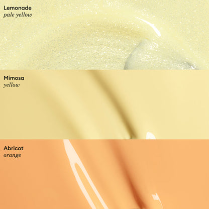 Three glossy, gel-like horizontal swatches: pale yellow labeled Lemonade, light yellow labeled Mimosa, and pastel apricot orange labeled Abricot by Manucurist, each with its color name in the corner.