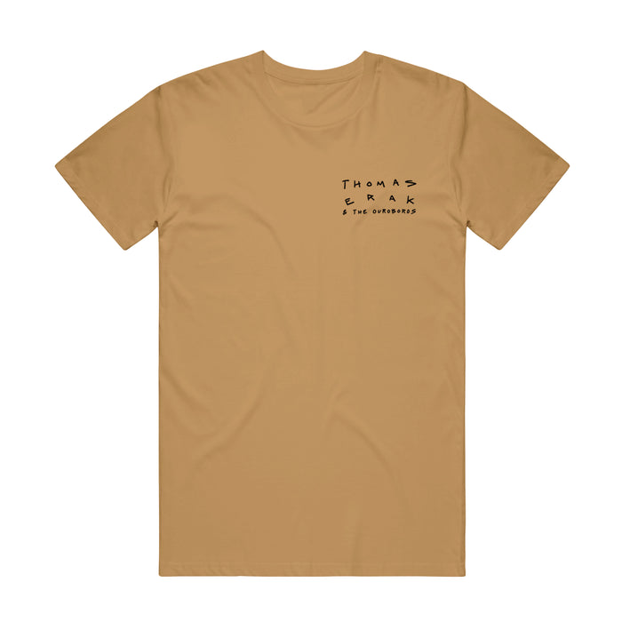 The front side of a golden colored shirt has "Thomas Erak and The Ouroboros" printed on the right side.