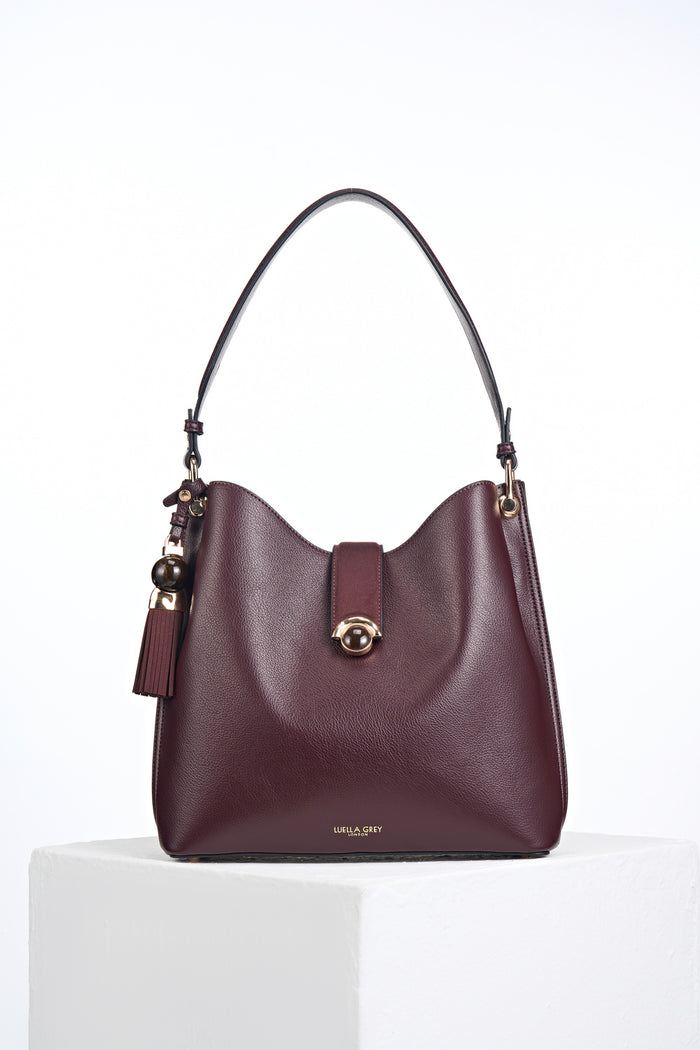 Front of the Andrea Black Cherry faux leather Hobo shoulder bag with Thames Tassel detail attached to the handle and a Crystal Palace clasp closure
