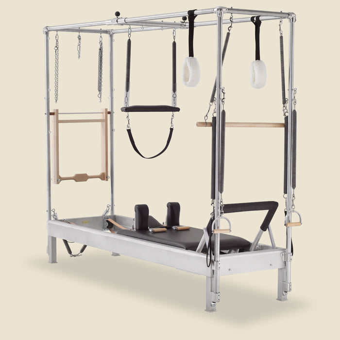 Gratz Pilates full Cadillac conversion reformer with hanging arm springs, straps, and trapeze.