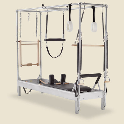 Gratz Pilates full Cadillac conversion reformer with hanging arm springs, straps, and trapeze.
