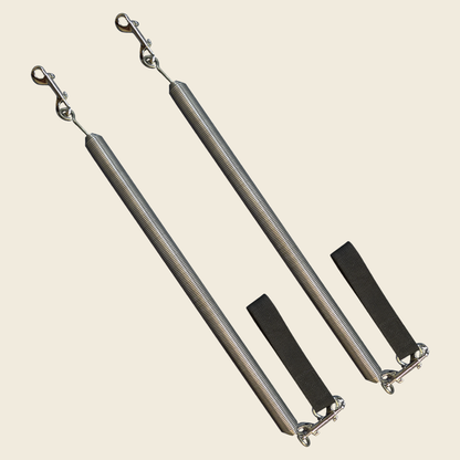 Pair of Gratz Pilates arm springs with black loop straps and double hooks assembly.