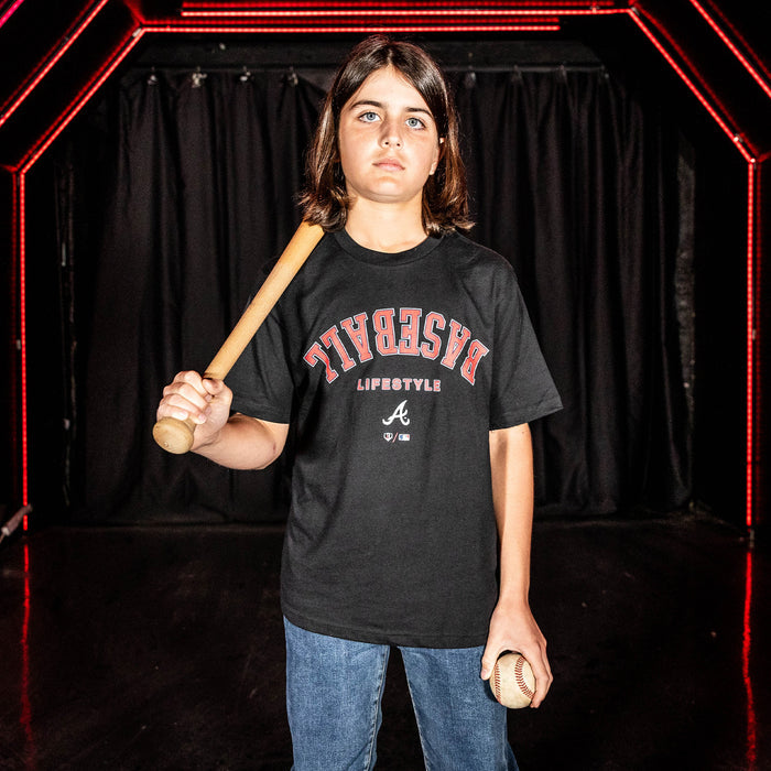 Youth model wearing black youth graphic tee with "Atlanta Braves Upside Down" design