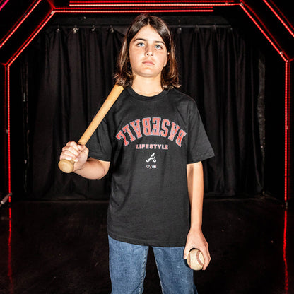 Youth model wearing black youth graphic tee with "Atlanta Braves Upside Down" design