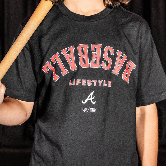 Youth model wearing black youth graphic tee with "Atlanta Braves Upside Down" design