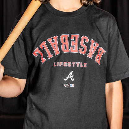 Youth model wearing black youth graphic tee with "Atlanta Braves Upside Down" design