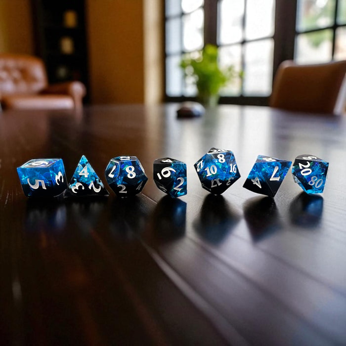 7-piece Black and Blue Prismatic RPG Dice Set with swirling resin and glitter, ideal for cosmic and dark fantasy campaigns.