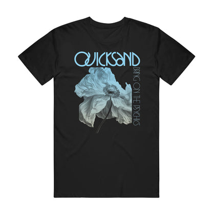 Quicksand black Comfort Colors tee with a large blue-gray flower at the center and light blue "QUICKSAND" and "BRING ON THE PSYCHS" text above and beside the design.