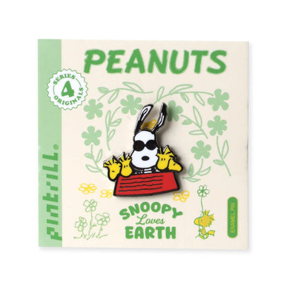 Snoopy enamel pin on PEANUTS card with green 'Snoopy Lover of Earth' text