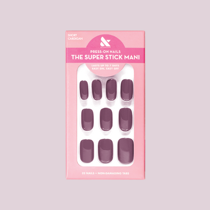 Cardigan | Short | Squoval - Tab Press-On nails in warm mauve shade displayed in pink packaging for easy at-home mani.