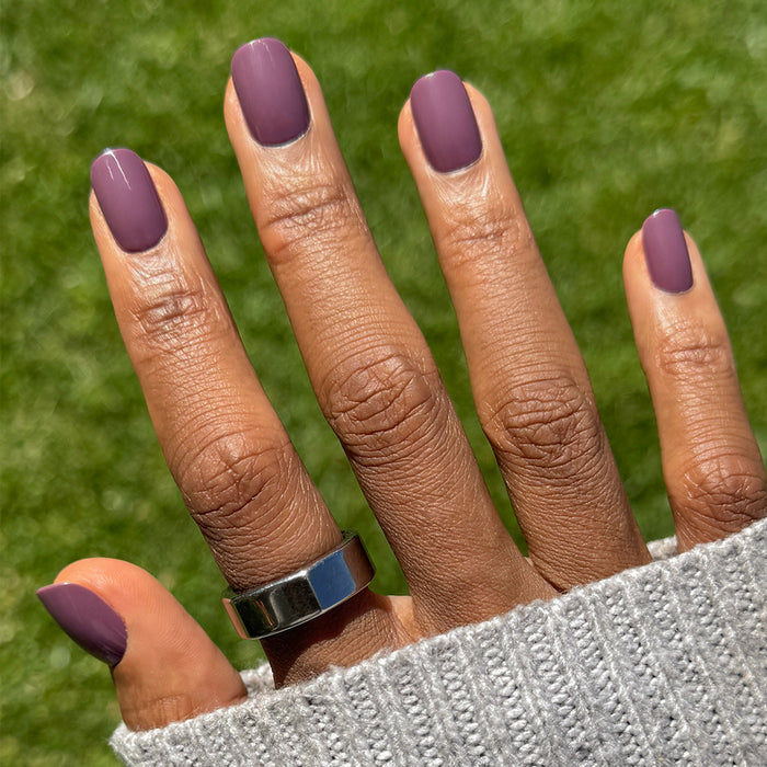 Cardigan | Short | Squoval - Tab Press-On nails in soft mauve shade with glossy finish on hand outdoors with silver ring and sweater sleeve