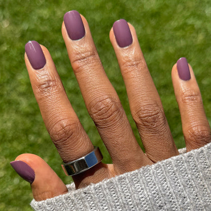 Cardigan | Short | Squoval - Tab Press-On nails in soft mauve shade with glossy finish on hand outdoors with silver ring and sweater sleeve
