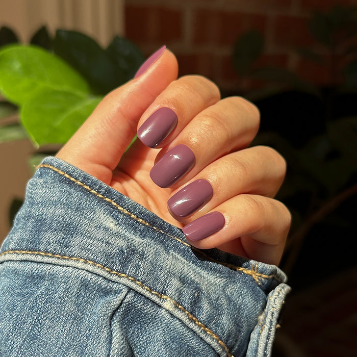 Cardigan | Short | Squoval - Tab Press-On nails in true mauve shade with glossy finish on hand in denim jacket sleeve outdoors