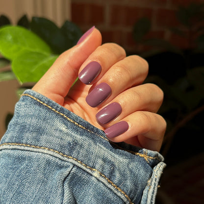 Cardigan | Short | Squoval - Tab Press-On nails in true mauve shade with glossy finish on hand in denim jacket sleeve outdoors