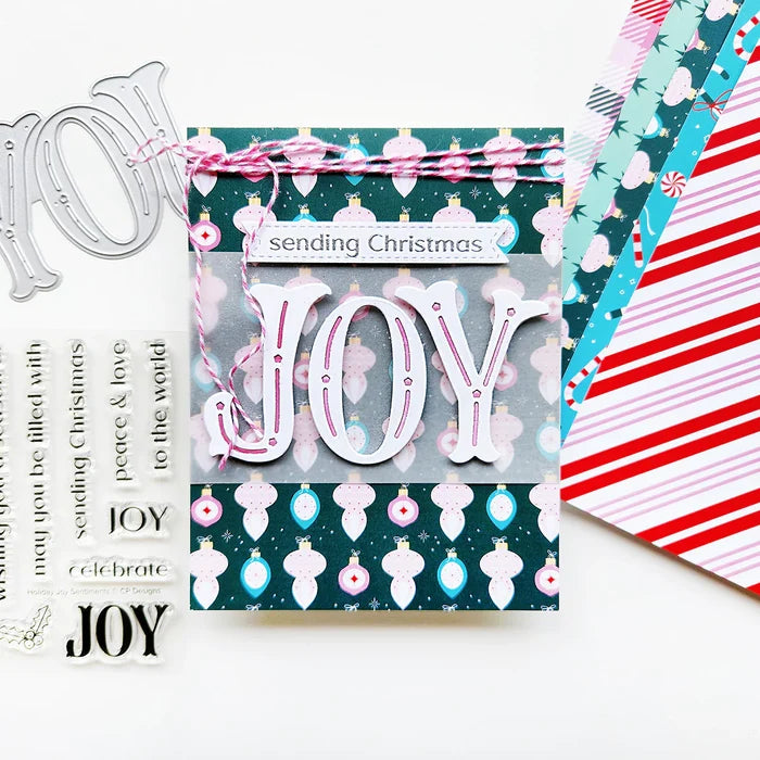 Catherine Pooler - Word Die - Festive Joy. Celebrate the season with the Festive Joy Word Die! This beautiful large "JOY" die can serve as the focal point of your holiday cards, adding a bold and cheerful touch. Available at Embellish Away located in Bowmanville Ontario Canada. Example by Catherine Pooler Designs.