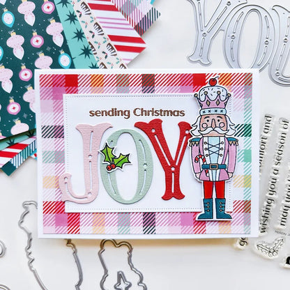 Catherine Pooler - Word Die - Festive Joy. Celebrate the season with the Festive Joy Word Die! This beautiful large "JOY" die can serve as the focal point of your holiday cards, adding a bold and cheerful touch. Available at Embellish Away located in Bowmanville Ontario Canada. Example by Catherine Pooler Designs.