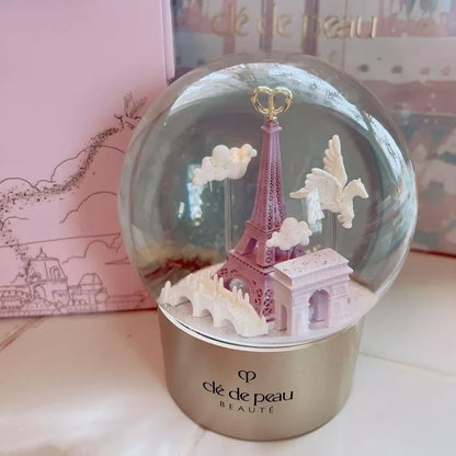 Cle de Peau Beauté Holiday Limited Edition Snow Globe, new in box, decorative home accessory with elegant design and winter scene.