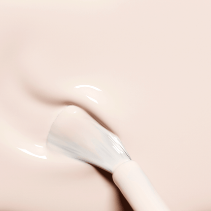 A brush applies Manucurist Crème, a milky pale pink gel nail polish, onto nails for a smooth, glossy finish with subtle swirls and a reflective sheen.