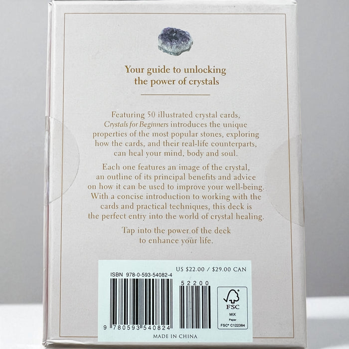 Card deck packaging titled 'Crystals for Beginners' by Judy Hall on a white background, Raven's Cauldron, 6 N Sandusky St, Delaware, OH 43015
