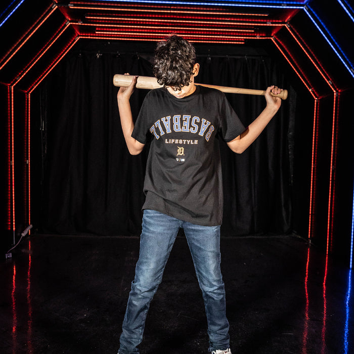 Youth model wearing black youth graphic tee with "Detroit Tigers Upside Down" design