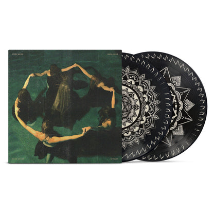A vinyl record set by Night Verses with a cover depicting six people in black holding hands in a circle. The records display black and white mandala-like patterns that form a mesmerizing zoetrope effect as they spin.