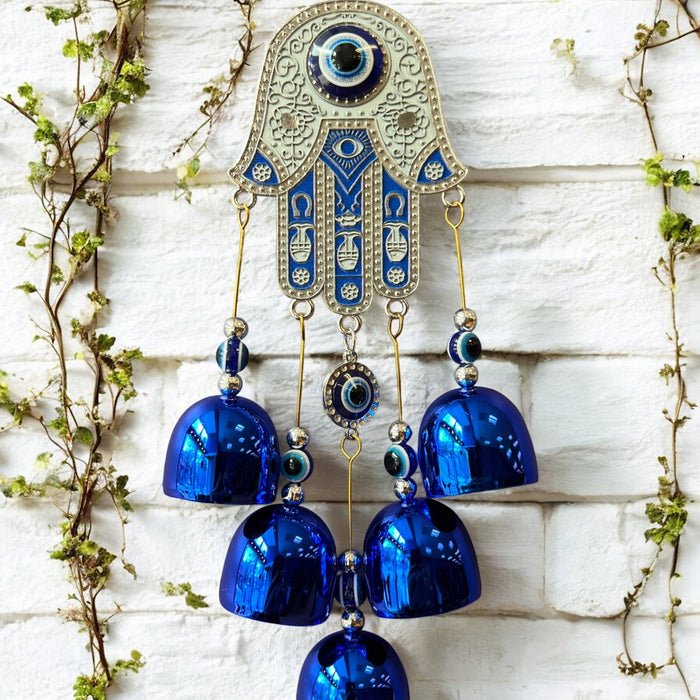 Brass Evil Eye Wind Chimes with five bells and Hand of Hamsa design, measuring 17 inches in length, hanging against a neutral background.