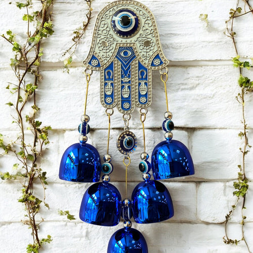 Brass Evil Eye Wind Chimes with five bells and Hand of Hamsa design, measuring 17 inches in length, hanging against a neutral background.