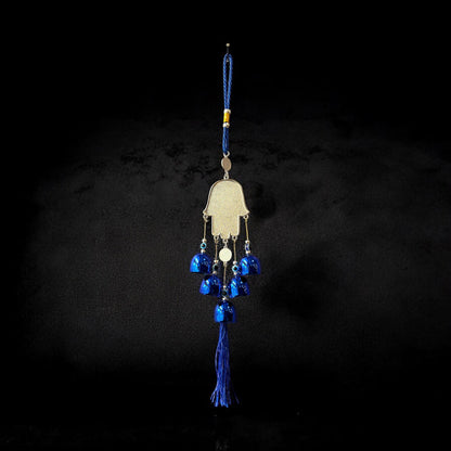 Brass Evil Eye Wind Chimes with five bells and Hand of Hamsa design, measuring 17 inches in length, hanging against a neutral background.