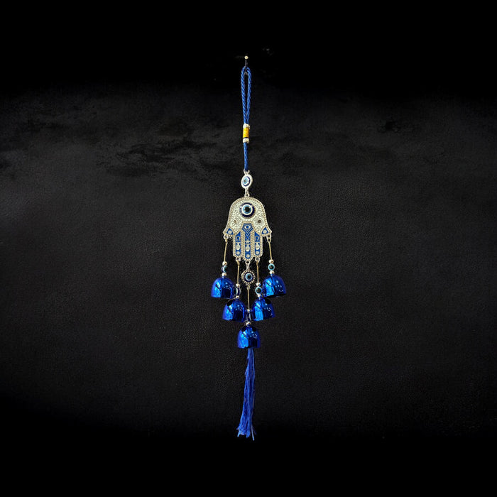 Brass Evil Eye Wind Chimes with five bells and Hand of Hamsa design, measuring 17 inches in length, hanging against a neutral background.