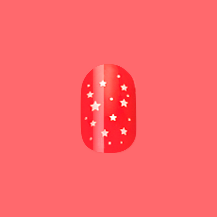Festive Stars | Extra Short | Round - Tab Press-On nail in bright red with small white star pattern on coral background