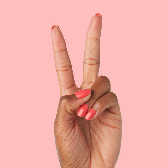 Hand showing peace sign with Field Day | Round | Extra Short press-on nails in glossy watermelon red on pink background