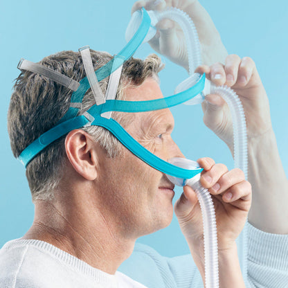 Man Putting on Evora CPAP Mask