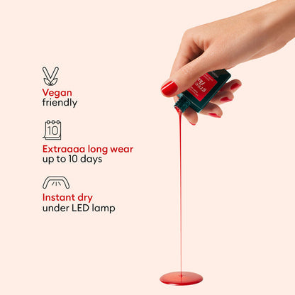 A hand with red-painted nails pours Manucurist Gift Set gel polish, forming a puddle. Text highlights: vegan friendly, extra long wear up to 10 days, and instant dry under LED travel lamp—each with its own icon.